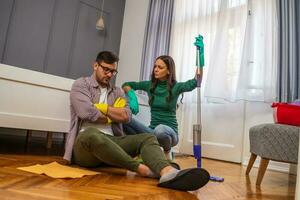 Young couple is cleaning their apartment photo