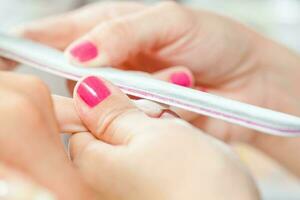 Nail treatment in a beauty salon photo