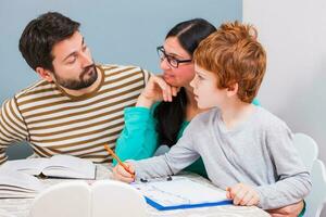 Parents helping their child with their homework photo