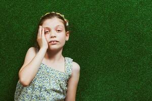 Little girl is lying on artificial grass photo