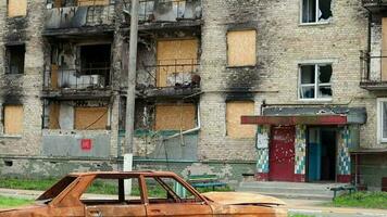 Consequences of the bombing in the city. The rocket blew up the house. A bombed-out apartment building and burnt-out cars after an airstrike. Holes in the walls from shells. Remains of property. video