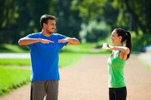 Young couple exercising outdoors photo