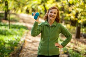 A senior woman doing physical exercises photo