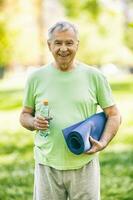 A senior man doing physical exercises photo