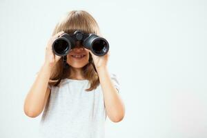 Portrait of a young girl with binoculars photo