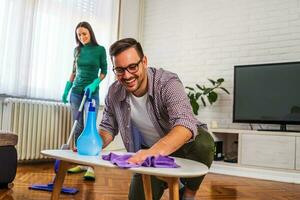 Young couple is cleaning their apartment photo