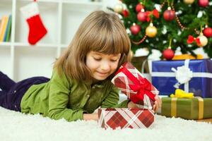 A young girl opening a gift photo