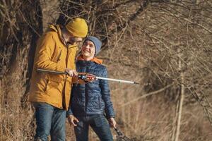 Father and son are fishing on sunny winter day photo