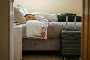 A tired businesswoman in her room after returning from a trip photo