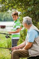 A grandfather and his nephew fishing photo