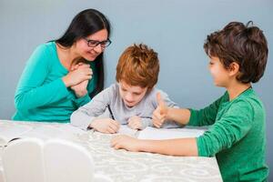 A mother helping her kids with the homework photo