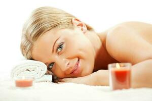 Young woman relaxing after massage on spa treatment photo