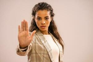 Portrait of a businesswoman with stop sign photo