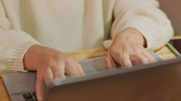 Woman sitting at desk and working on laptop in office at home close-up. Close up of woman hand using laptop sitting in office and doing research. video