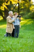 A grandfather and his grandson spending time together outdoors photo