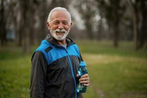 A senior man doing physical exercises photo