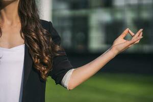 Businesswoman taking a break and meditating outside of the company building photo