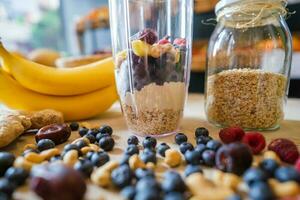 Healthy protein shake on table with fruits and vegetables ingredients around photo