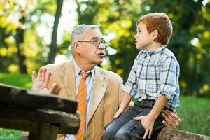 A grandfather and his nephew spending time together outdoors photo