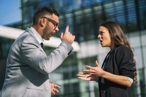 Business colleagues are arguing outside the company building. photo