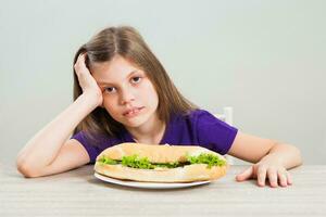 A girl eating a sandwich photo