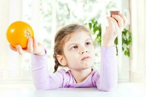 Little girl with fruits for health and wellness concept photo