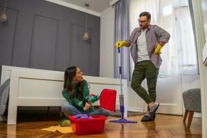 Young couple is cleaning their apartment photo