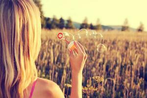 A woman making soap bubbles photo