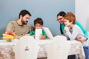 Parents are teaching their children to use the laptop photo