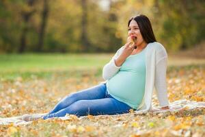 A pregnant woman spending time outdoors photo