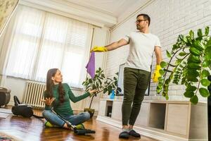 Young couple is cleaning their apartment photo