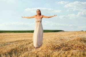 Woman with open arms outdoors photo