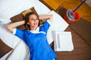 A maid working in a hotel room photo