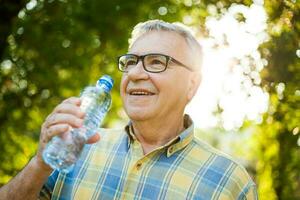 A senior man drinking water photo