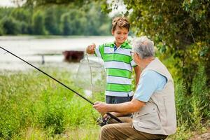 A grandfather and his nephew fishing photo