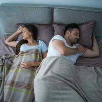 A young couple lying in bed photo