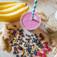 Healthy protein shake on table with fruits and vegetables ingredients around photo