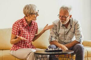 A senior couple playing chess. photo