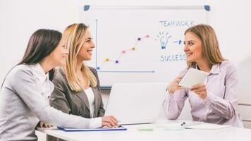 Businesswomen discussing business plan photo