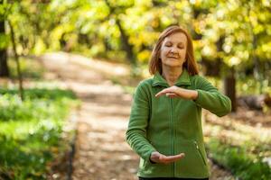 A senior woman doing physical exercises photo