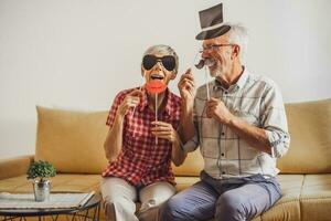 Happy mature couple is having fun at home. photo