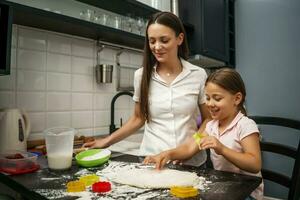 Mother and daughter cooking together photo