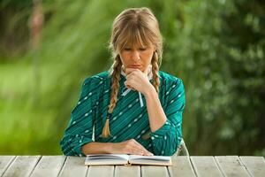 A woman reading at the table photo