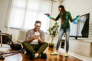 Young couple is cleaning their apartment photo