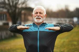 A senior man doing physical exercises photo