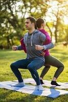 Couple exercising together in the park photo