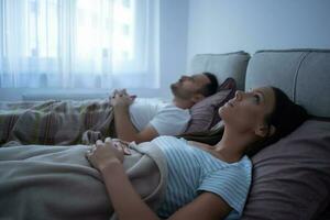 A young couple lying in bed photo