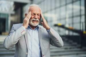 A senior businessman having a headache photo