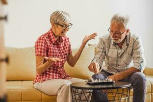 A senior couple playing chess. photo