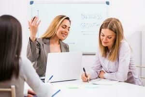 Businesswomen discussing business plan photo